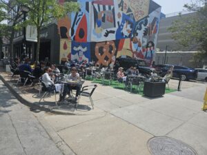 Taq expected so much business that they expanded their sidewalk seating into the parking lot across the alley. They were right. Photo by Drew Saunders.