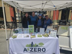 Dir. Missy Stults, wearing the blue glasses, with her A2ZERO team at Taste of Ann Arbor. Photo by Drew Saunders.