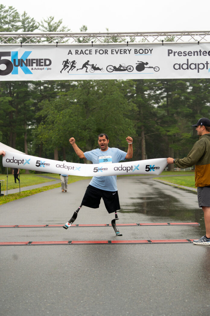 Massachusetts AdaptX Unified 5K 2025 inclusive road race double amputee crosses finish line