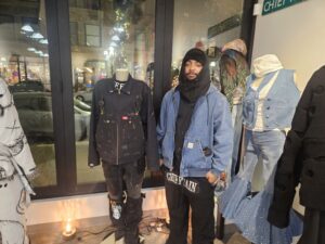 Paris Green, standing amongst his custom clothing. Photo by Drew Saunders.