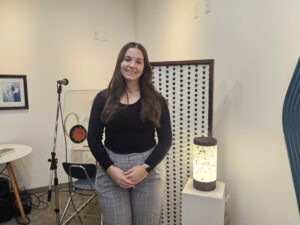 Delanie Shorten standing next to the lamp that she made. Photo by Drew Saunders.
