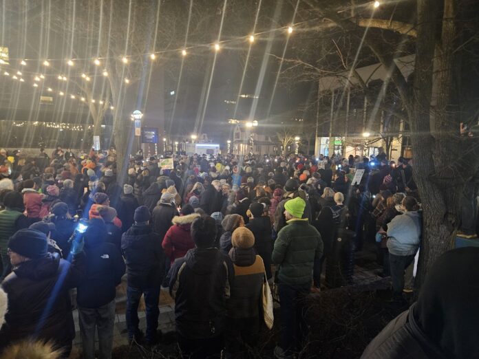 The poetry vigil to remember Renee Good and protests the immigration policy and behavior of the Trump Administration on Friday rivaled that of some of the Sonic Lunch concerts that happen in that same park every summer. Photo by Drew Saunders.