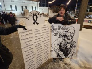 Helen Bunch with her signs. Photo by Drew Saunders.