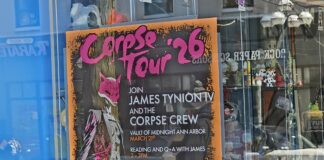 The Corpse Tour '26 poster in the front window of Vault of Midnight. Photo by Drew Saunders.