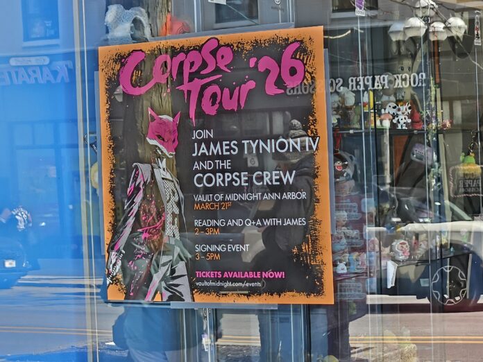 The Corpse Tour '26 poster in the front window of Vault of Midnight. Photo by Drew Saunders.