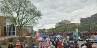 Crowd at the May Day resource rally held by A2 Indivisible. Photo by Drew Saunders.